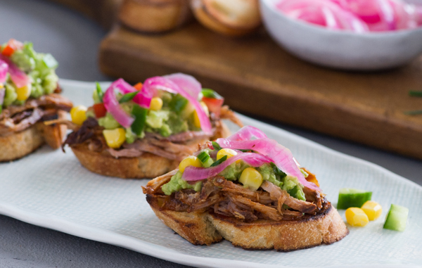 Pork, Avocado and Sweet Corn Crostini with Pickled Onions Recipe